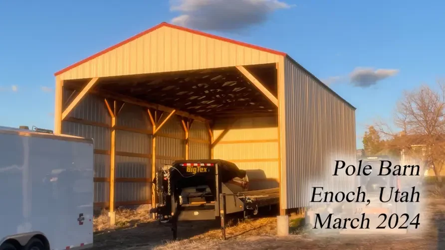 A pole barn under construction with wooden framing and a metal roof in Enoch, Utah, February 2024.