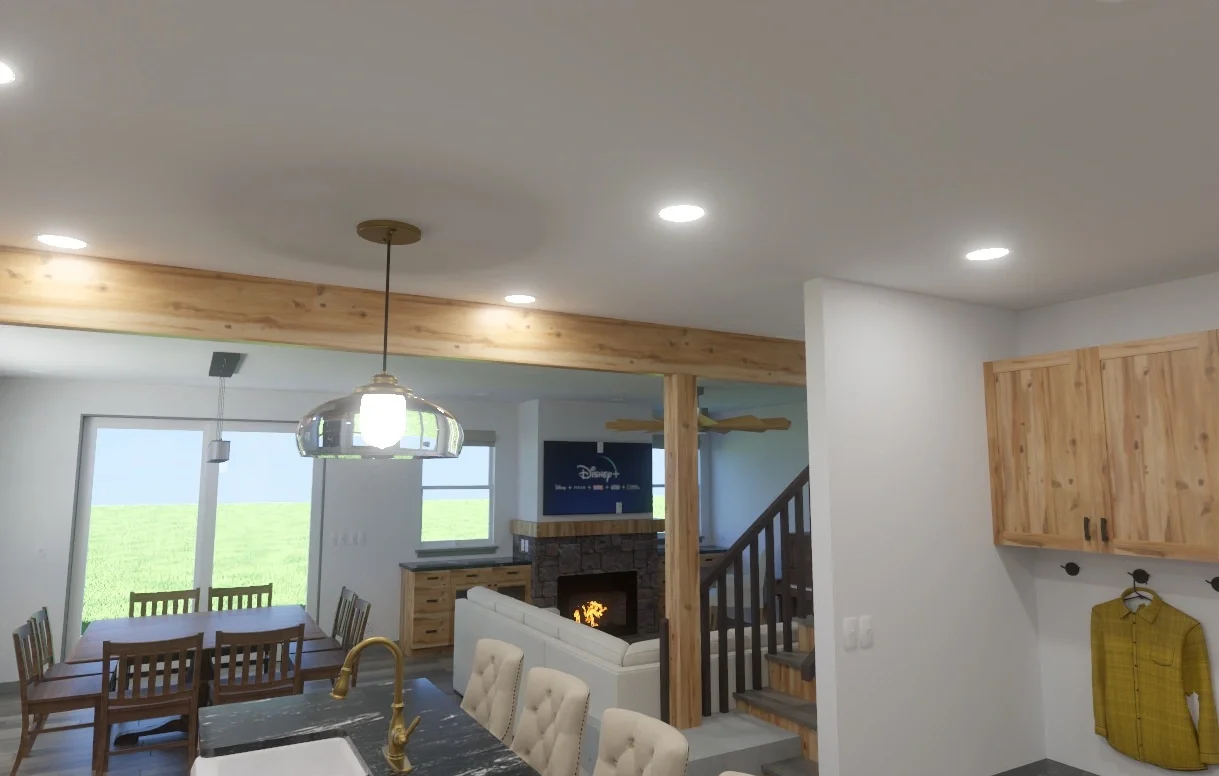Interior of a modern living space with a dining table, kitchen island with a sink, a fireplace, and a staircase. Light-colored wooden cabinets and accents are visible.