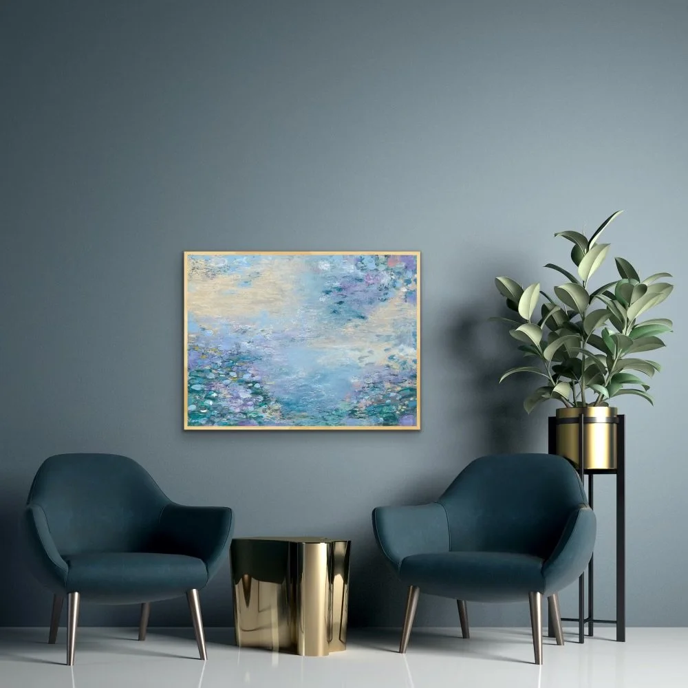 Modern living room with blue armchairs, a gold side table, a large potted plant, and a painting of water lilies on the blue wall.
