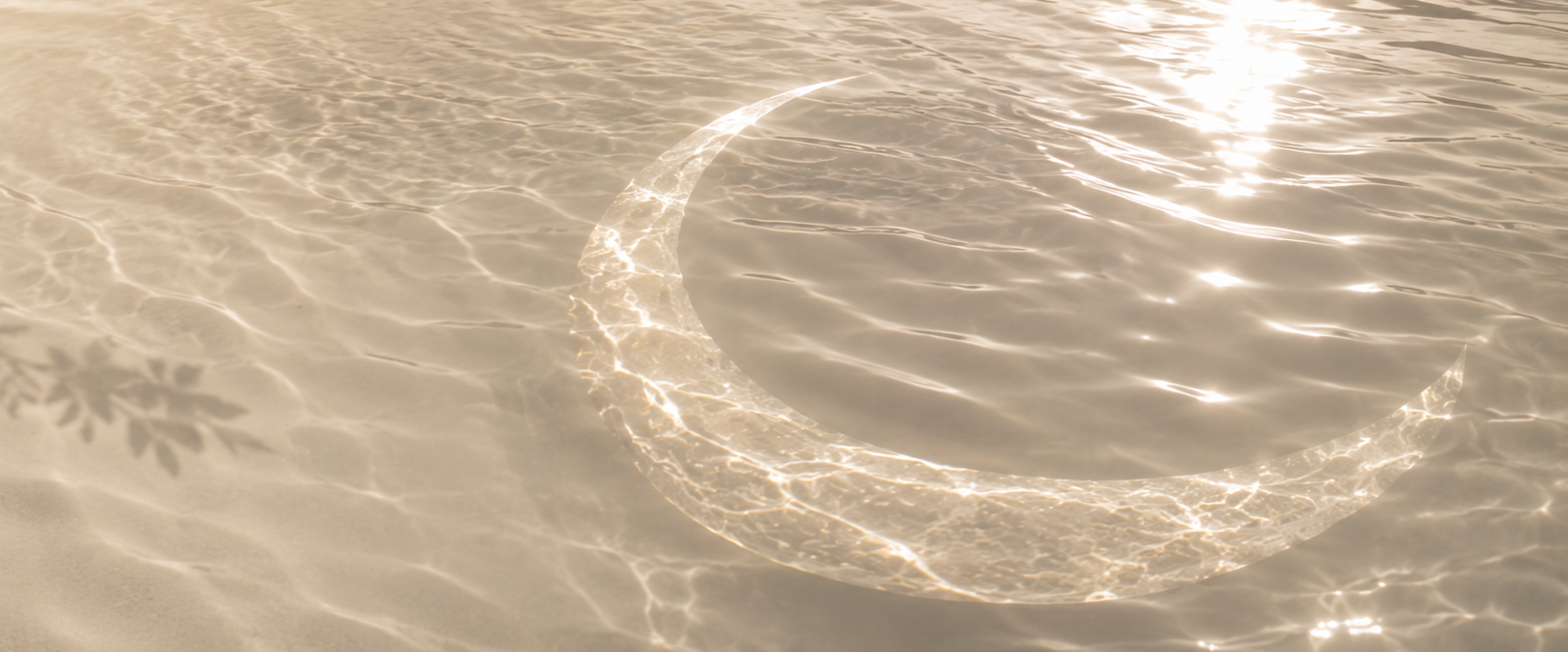 Clear water in a pool with a shimmering crescent moon and star-shaped shadow on the pool floor