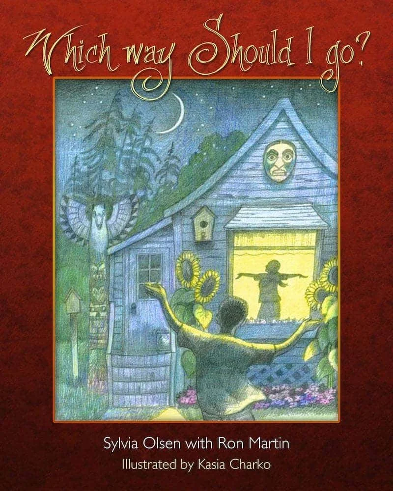 A book cover titled "Which way should I do?" by Sylvia Olsen with Ron Martin, illustrated by Kasia Charko. The cover features a colorful illustration of a person with arms outstretched standing in front of a house and a window showing a larger face.