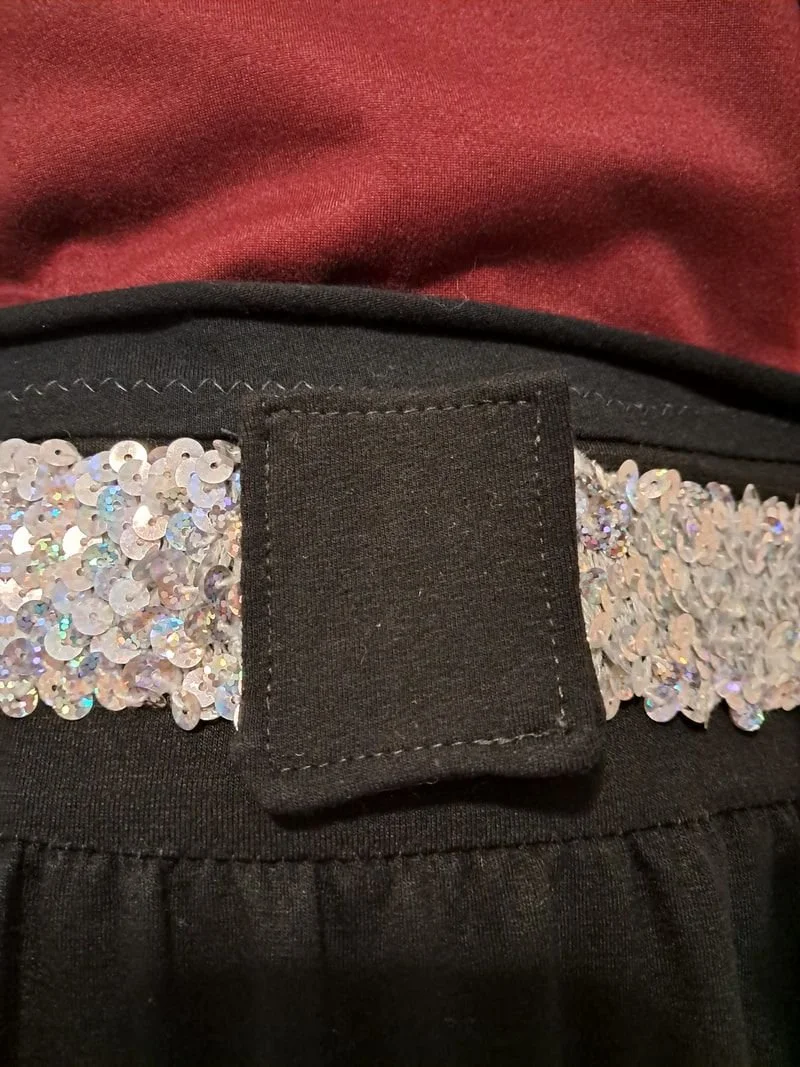 Silver sequin belt with a black fabric clasp cover