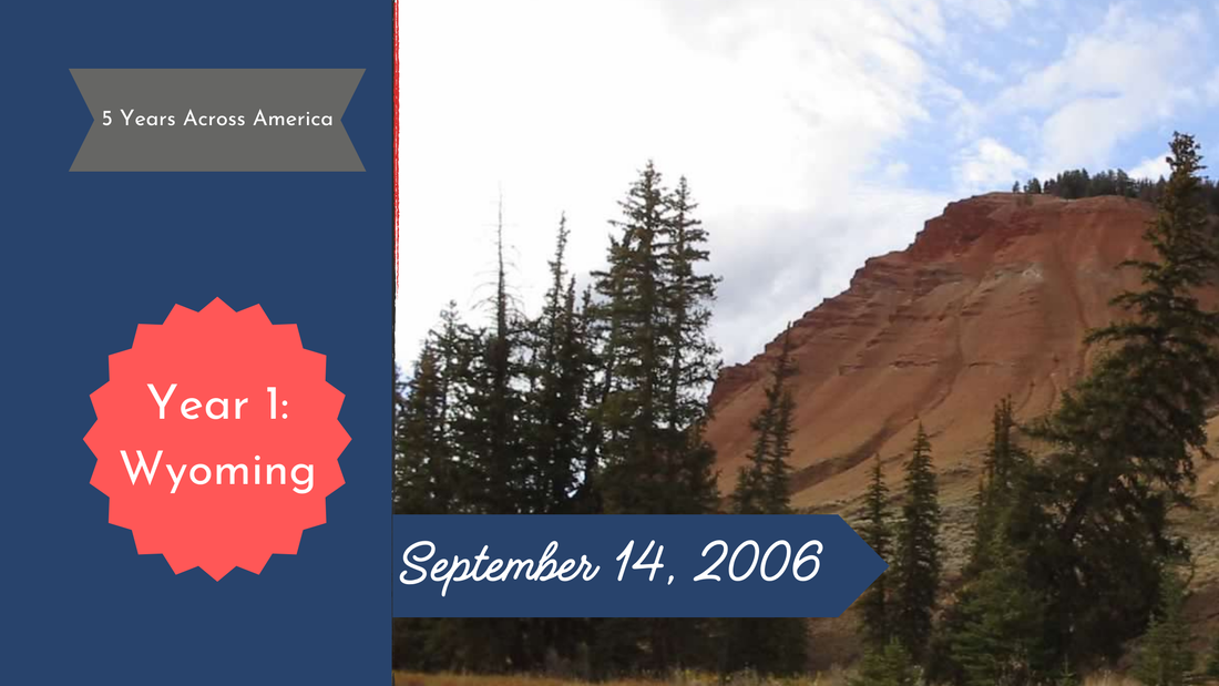 Red butte cliff with evergreen trees