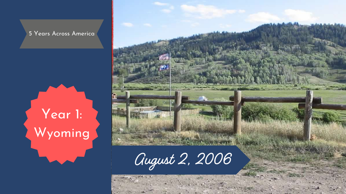 View of Wyoming hills behind a ranch fence and field