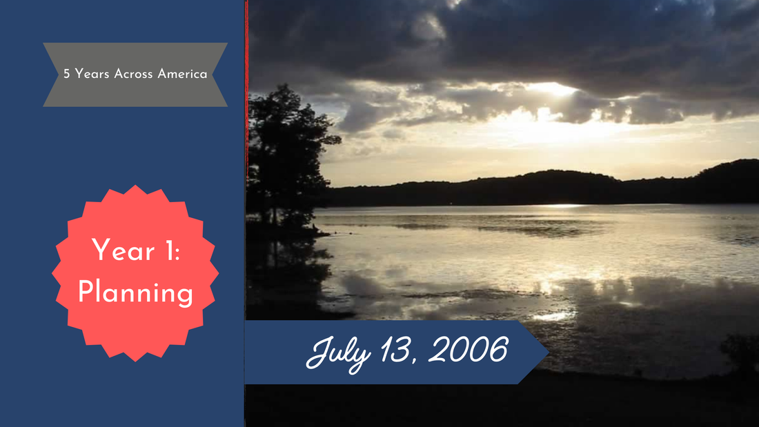 Sunset over a lake with a hill in the background