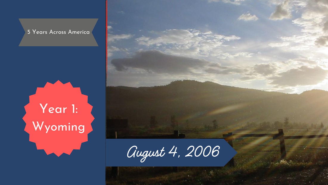 Sun shines through clouds over a Wyoming hill