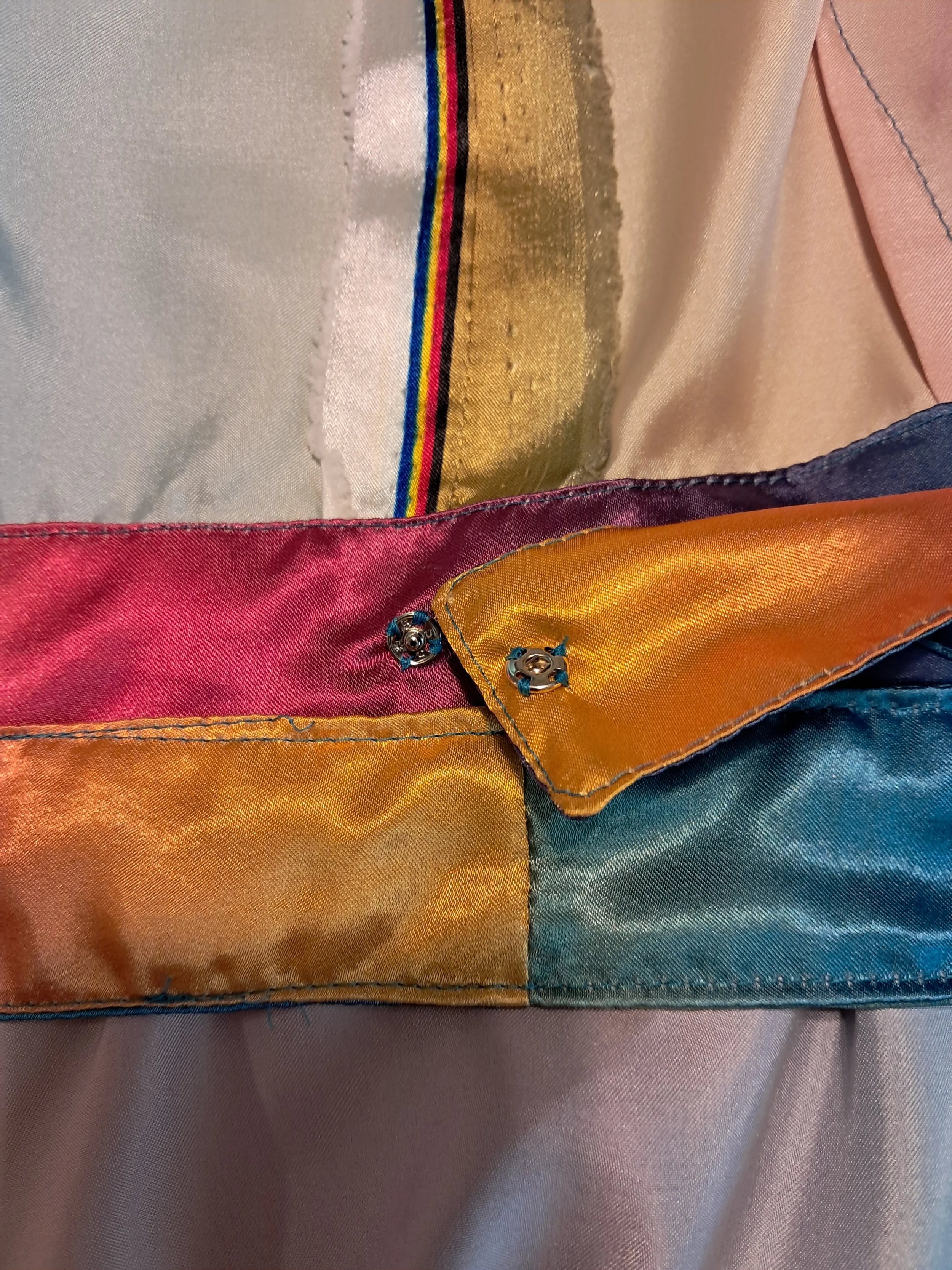The inside of a dress, showing the waist sash with snaps