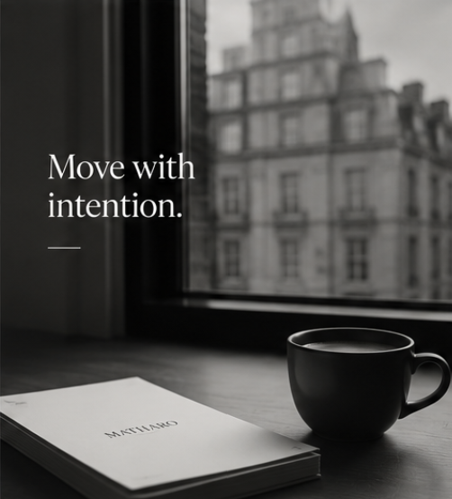 A black coffee mug and a closed planner with 'METHOD' written on it, placed on a windowsill with a city building view, accompanied by the text 'Move with intention.'