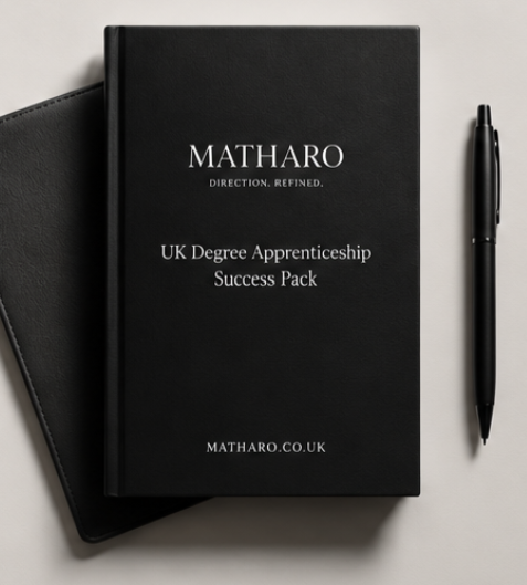 Black MATHARO notebook with white text, next to a black pen and another black item, on a light gray surface.