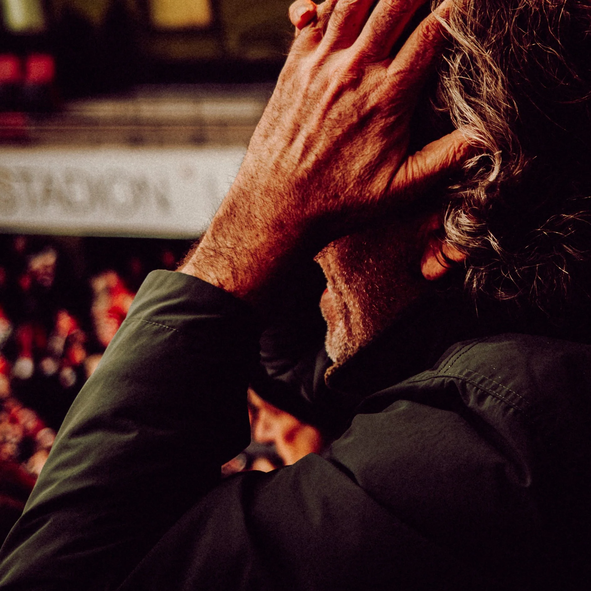 A football fan expressing his anger whilst watching the game.
