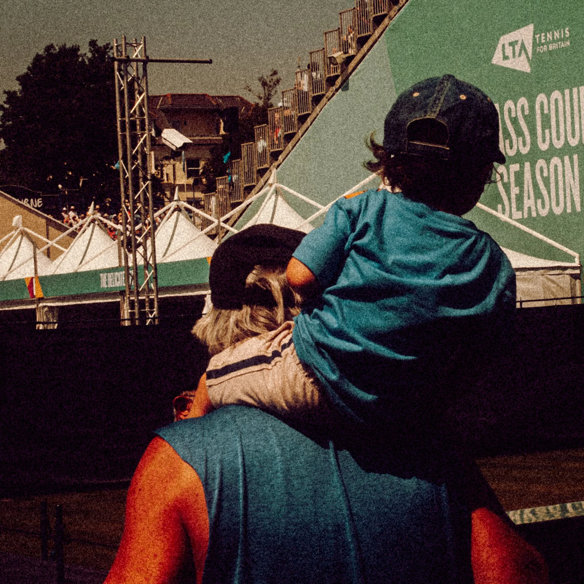 A boy with his grandad at the tennis