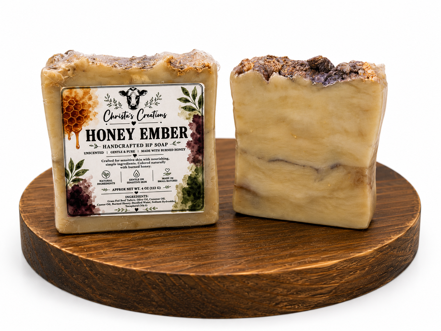Unwrapped Honey Ember tallow soap displayed upright on a round wooden stand.