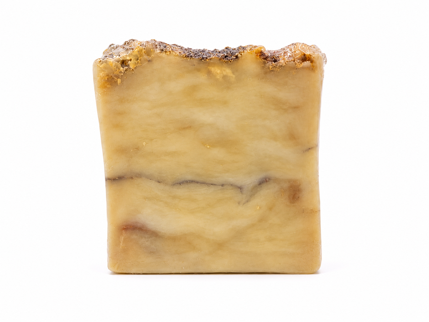 Unwrapped Honey Ember soap bar with creamy beige marbling and a rustic textured top.