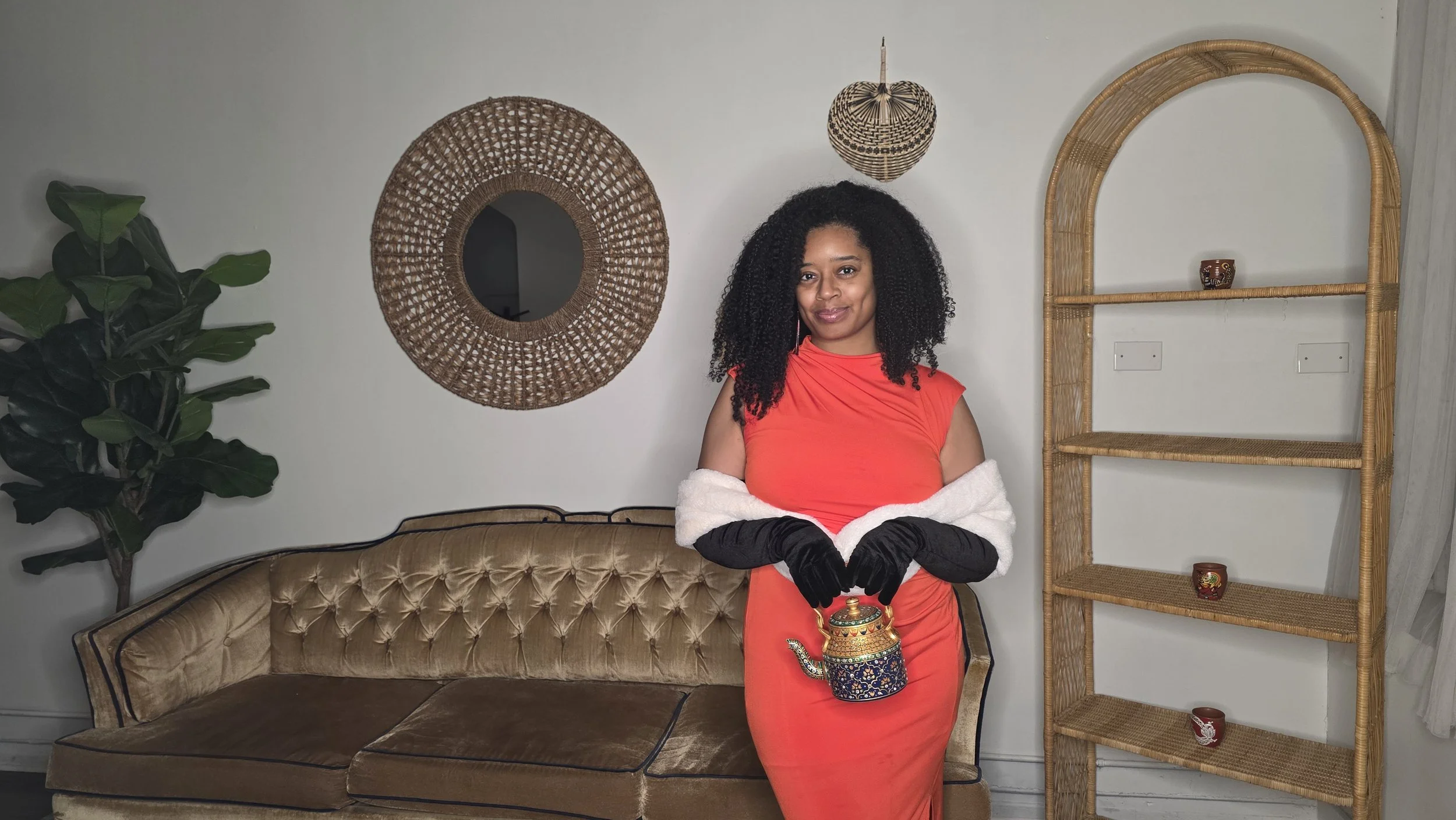 Tiara Starks, Founder of Luxe Tea, holding a teapot