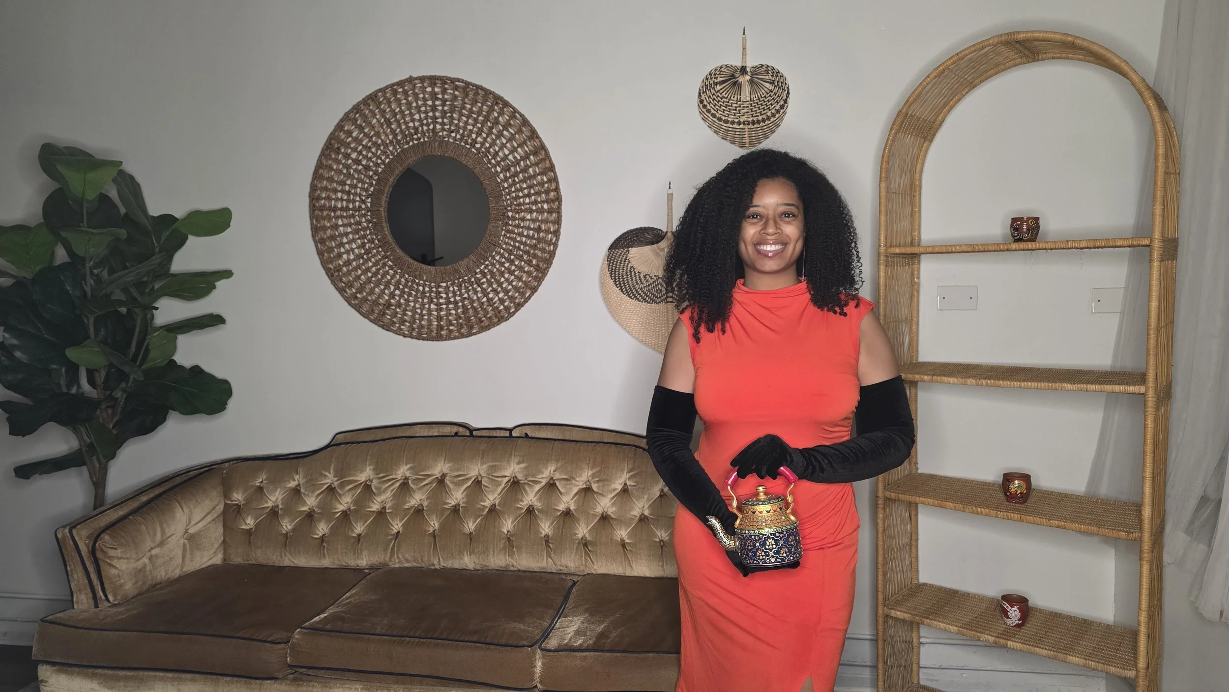 Luxe Tea Founder, Tiara Starks, smiling holding an ornate teapot