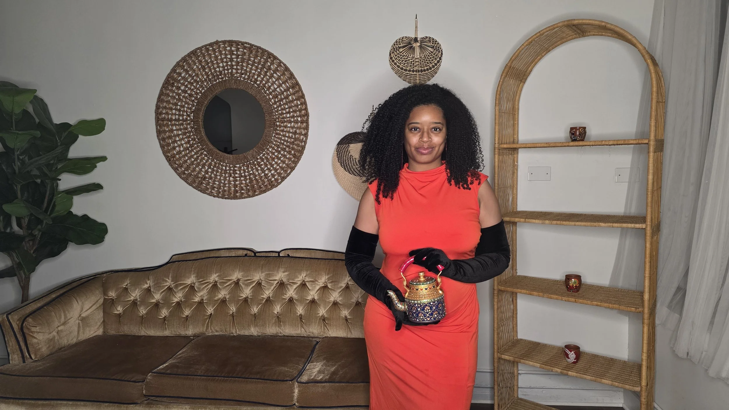 Luxe Tea Founder Tiara Starks holding an ornate teapot