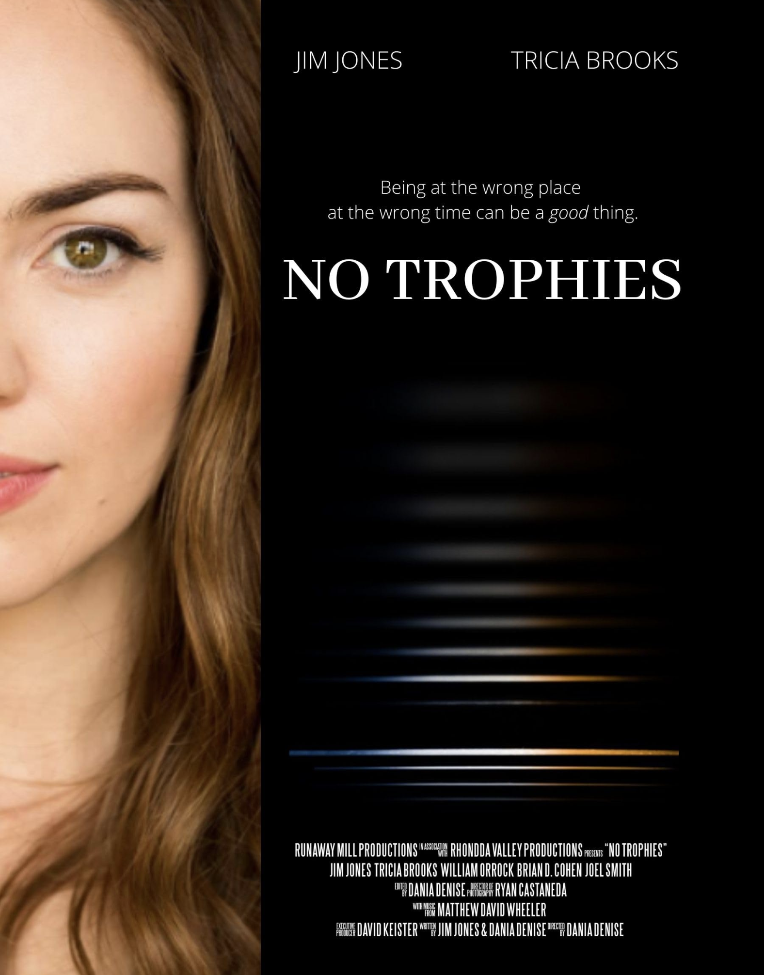 The image features a woman's face on the left side with only her eye, part of her cheek, and hair visible. The right side of the image contains text for a movie titled 'No Trophies,' including names of actors Jim Jones and Tricia Brooks, along with credits for production and directing companies and individuals.