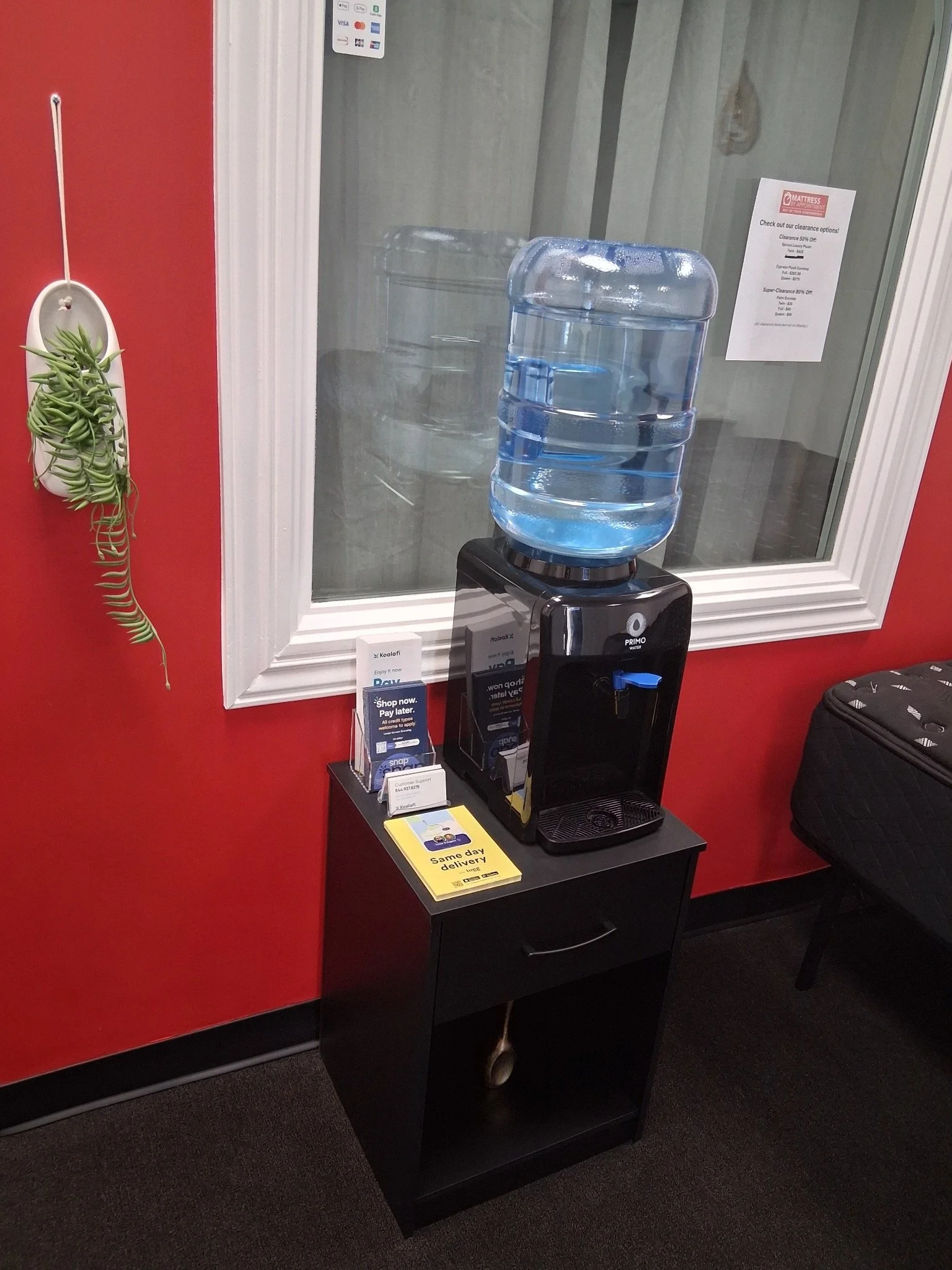 MBA-SLC Water Dispenser With Clearance Item Poster And Financing Educational Documents Directly Adjacent