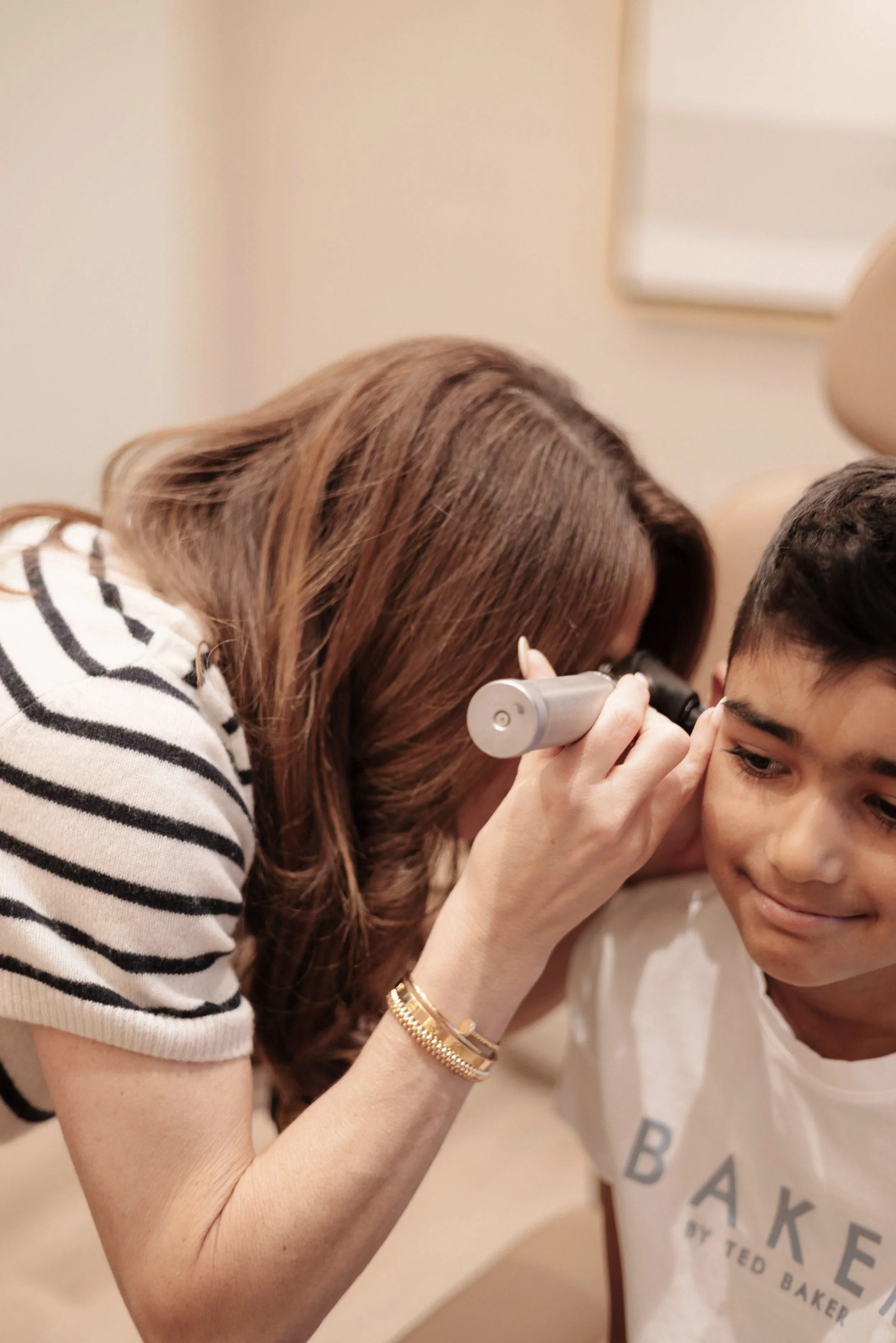 Dr. Lisa Zia performing an ear exam during well-child visit in Las Vegas