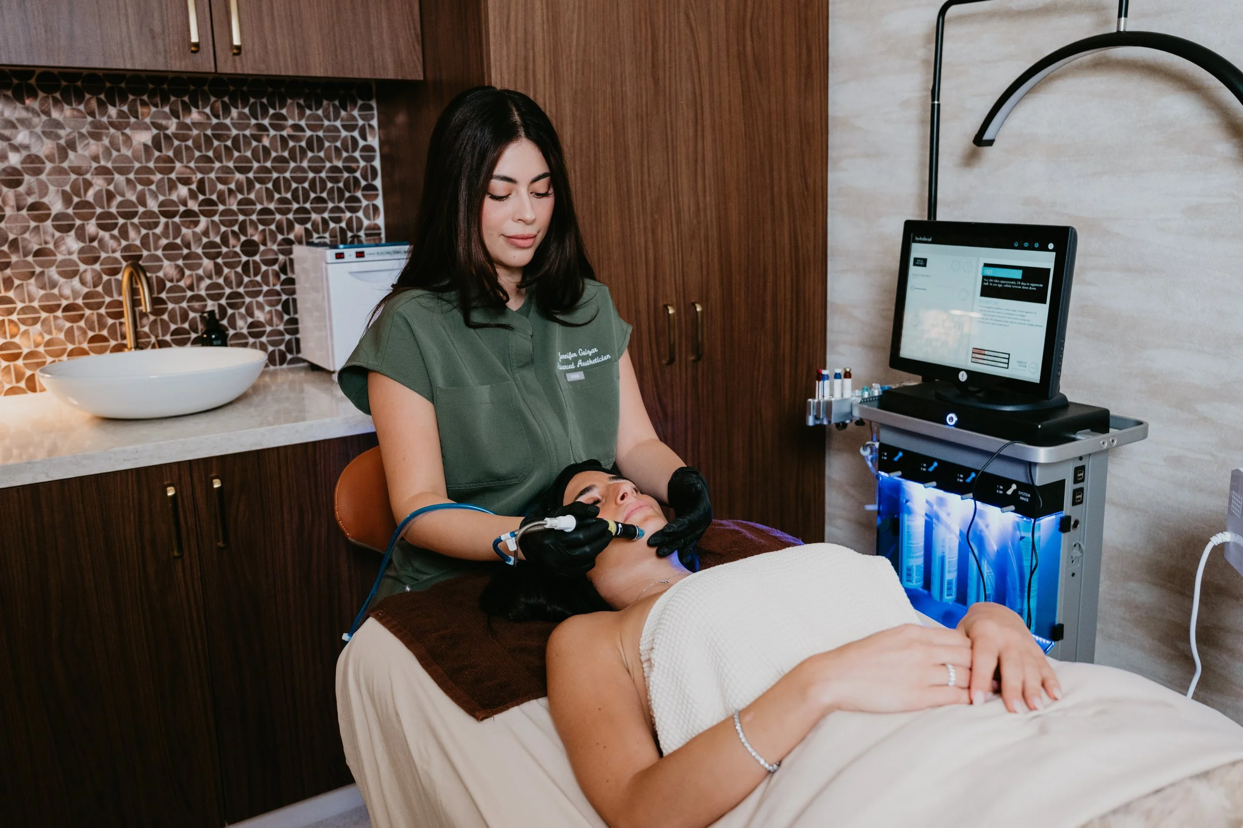 A client receiving a HydraFacial by Jennifer, an advanced esthetician at Estetica Medspa in Las Vegas
