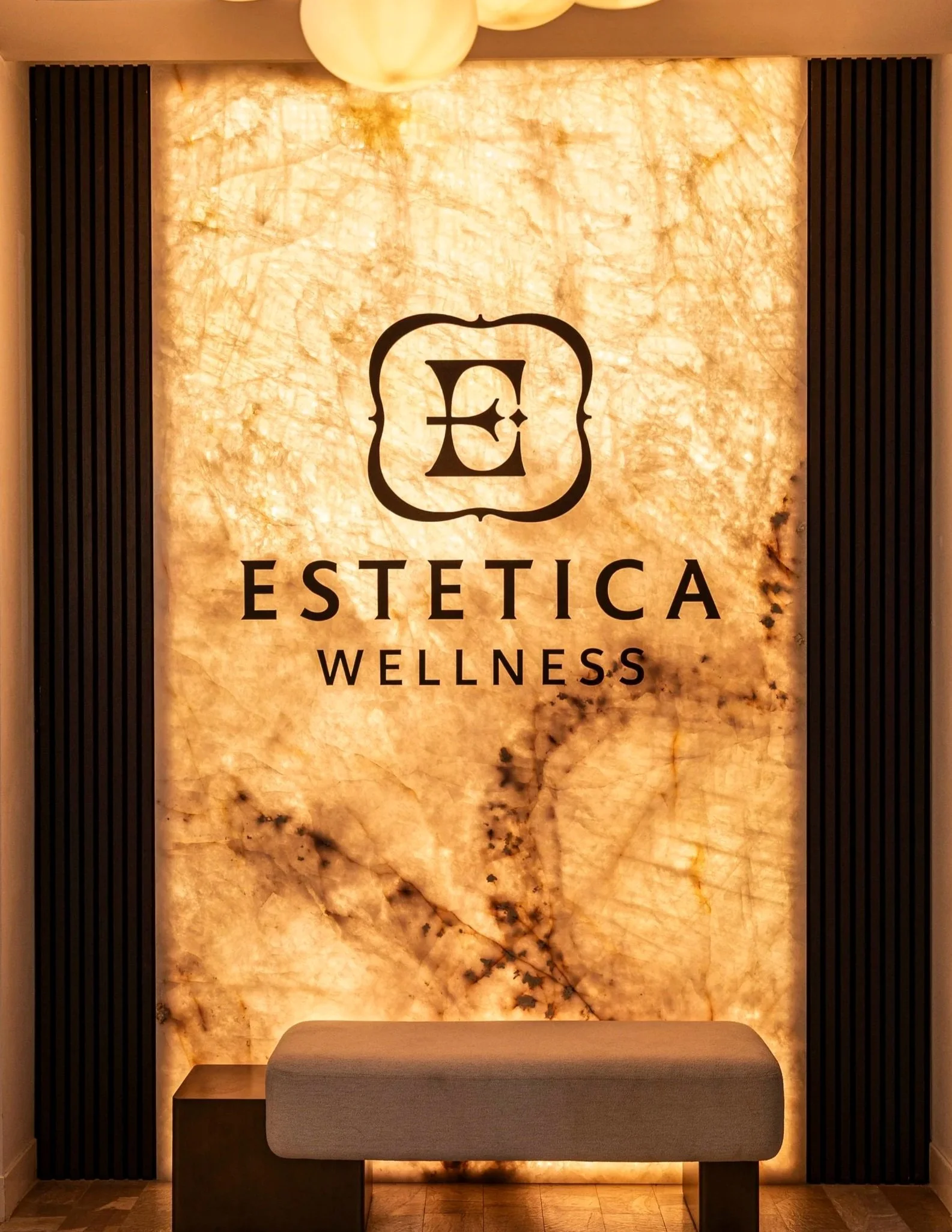 Estetica wellness & Medspa interior logo wall at our Las Vegas wellness and aesthetics clinic