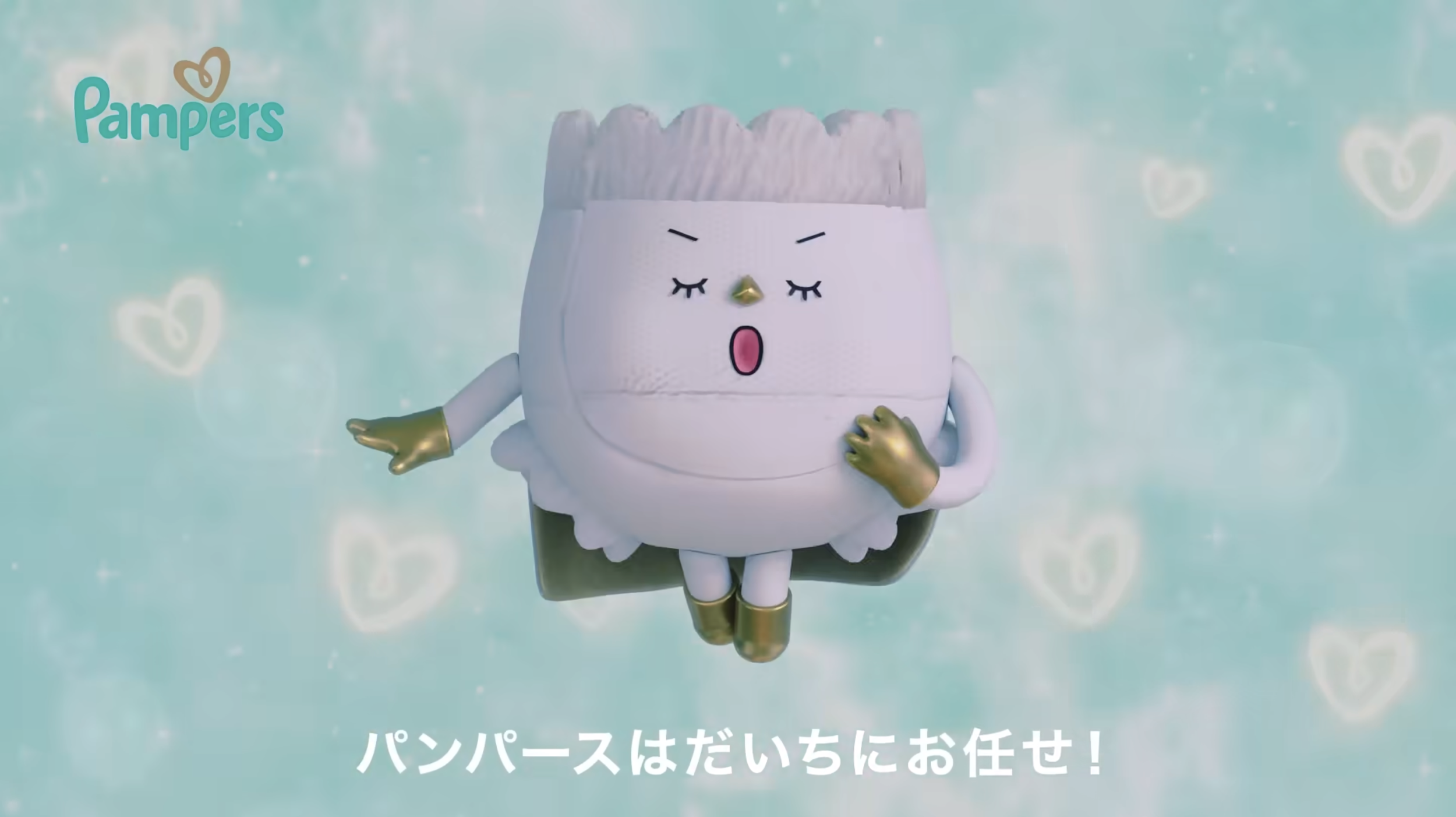 A mascot character resembling a roll of bread with a face, wearing golden shoes and gloves, with closed eyes and an open mouth, standing against a light blue background with heart patterns and Japanese text at the bottom.