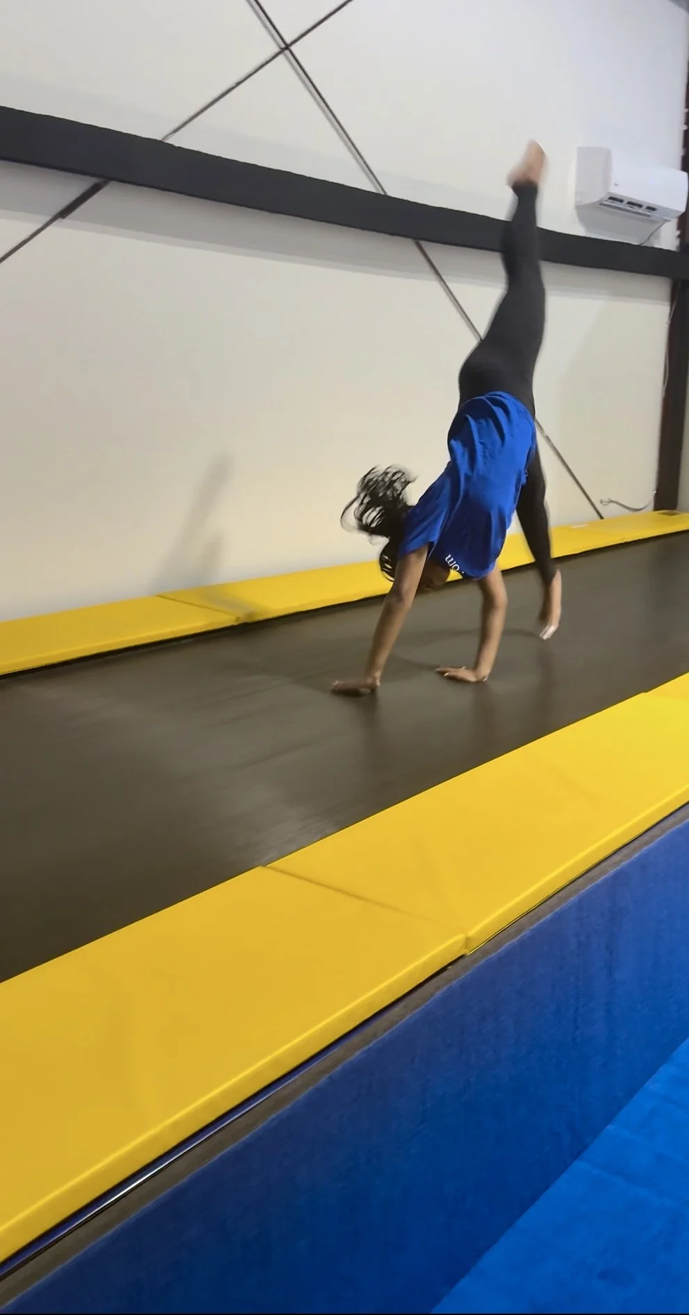 Athlete performing a round-off on the tumble track at Flip'n Xperts in Northwest Oklahoma City during tumbling practice