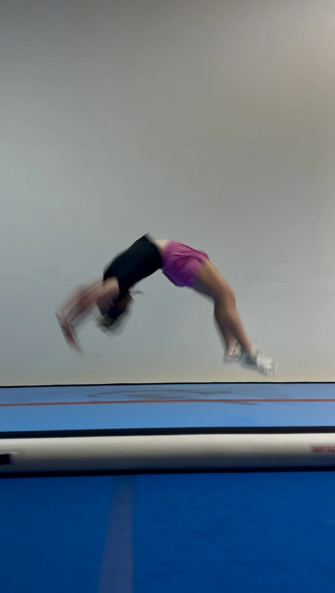Athlete performing a back handspring on the AirTrack Pro at Flip'n Xperts in Northwest Oklahoma City during tumbling practice