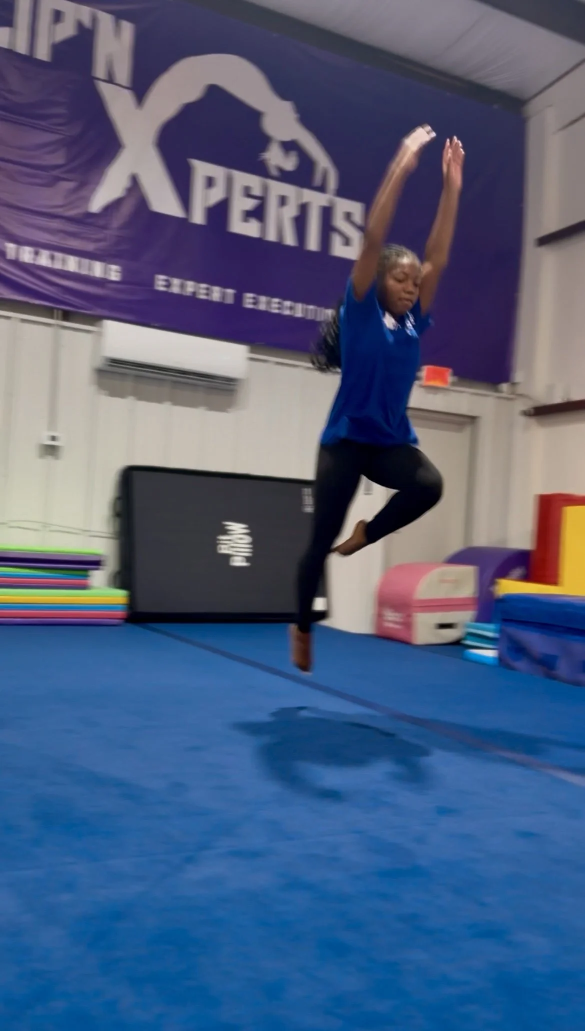 Athlete performing the hurdle into a front aerial on the spring floor at Flip'n Xperts in Northwest Oklahoma City during tumbling practice.