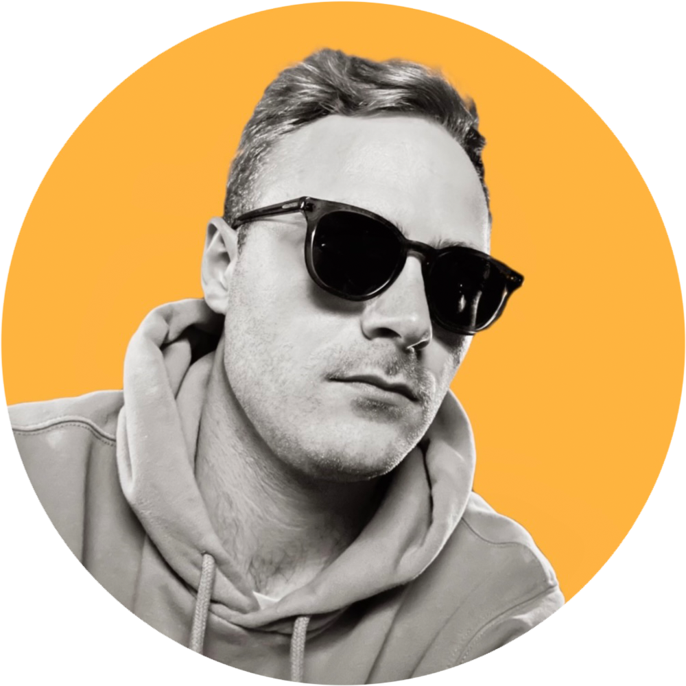Black and white photo of a man wearing sunglasses and a hoodie, with a yellow background.
