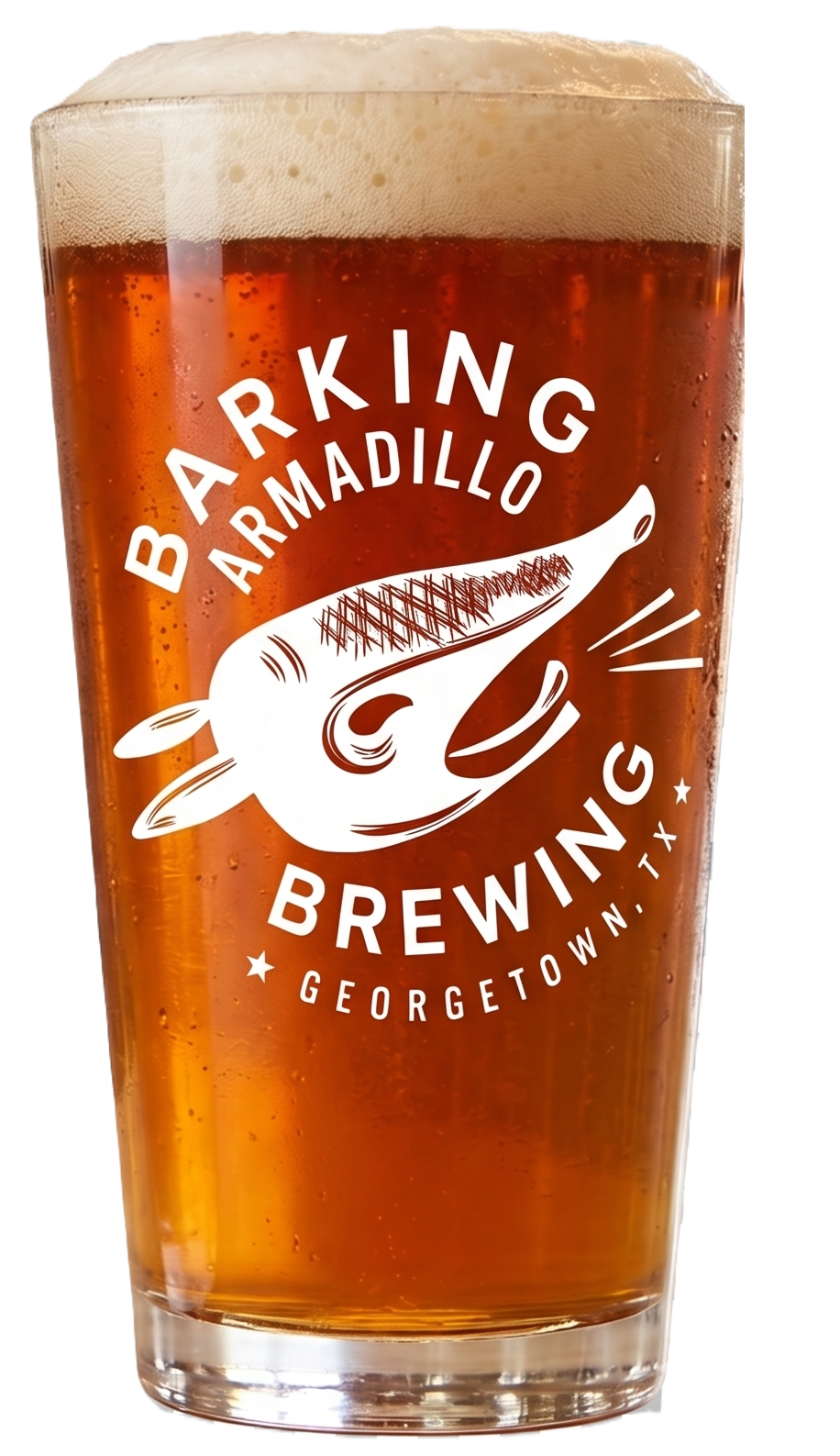 A pint glass filled with amber-colored beer with a frothy head, featuring a white logo of a whale and text for Blacking Armadillo Brewing in Georgetown, TX.