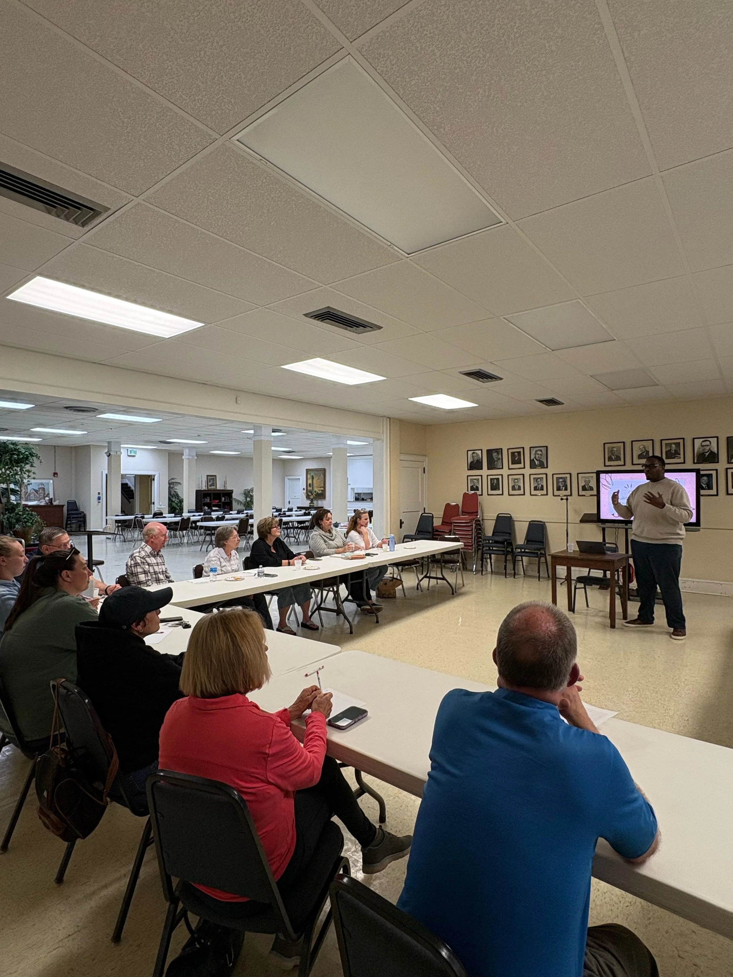 Organization leader giving a presentation to a group of community members.