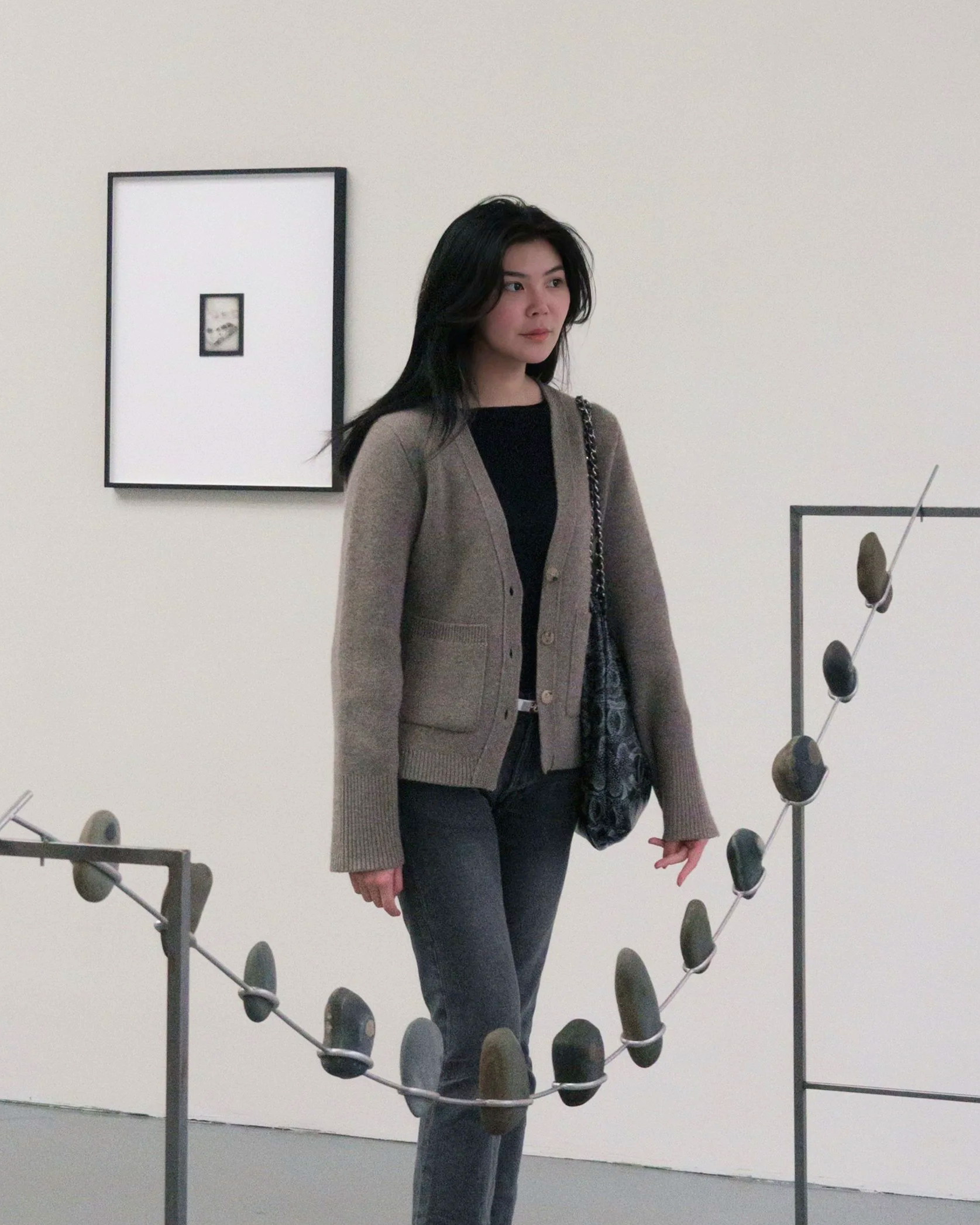 Founder of Trace Out Art Advisory, Tracy Yuan standing in in between artworks giving a museum guided tour for her clients.