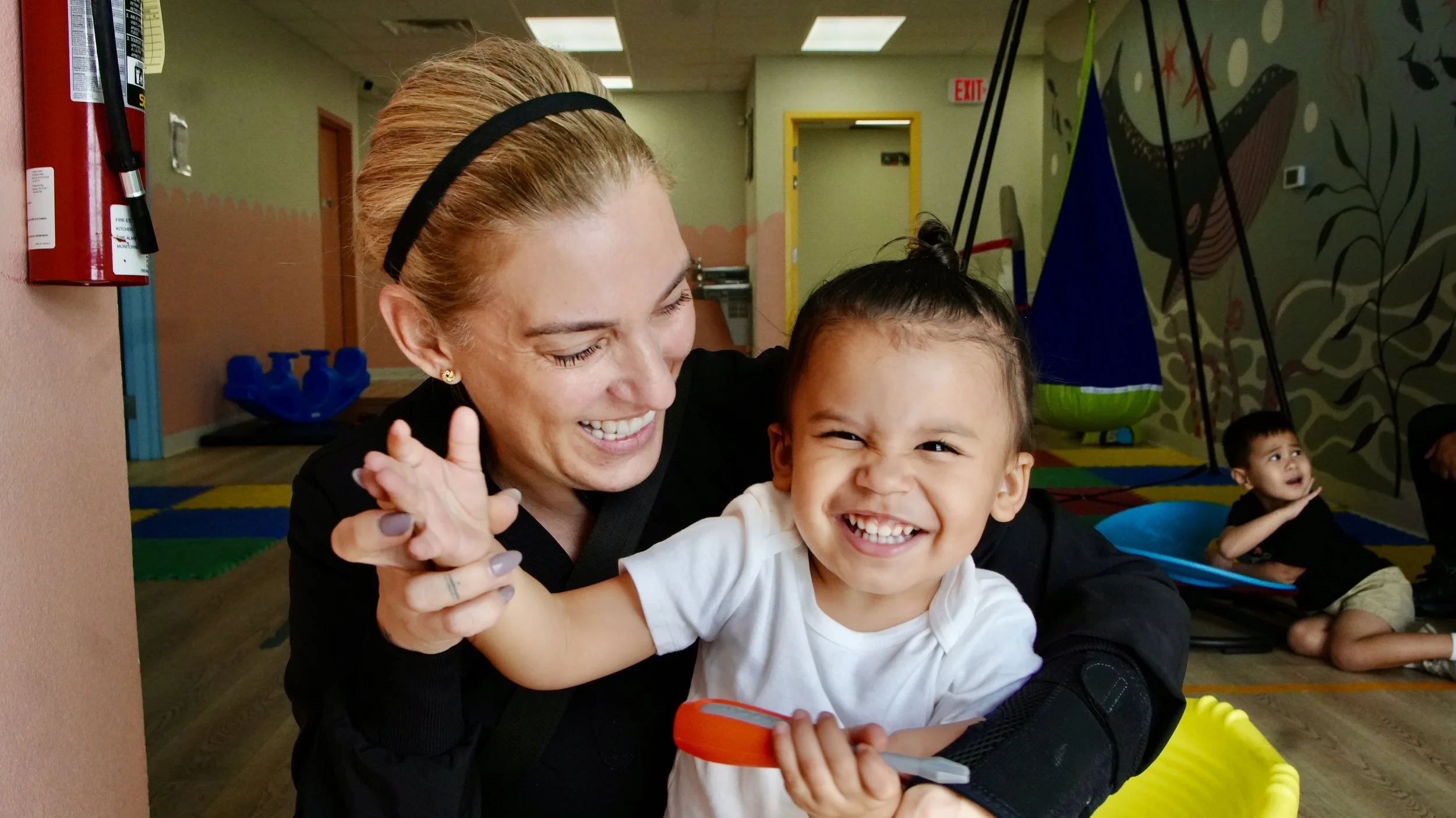 Autism Care Compass team member engaging with a child during a play-based activity.