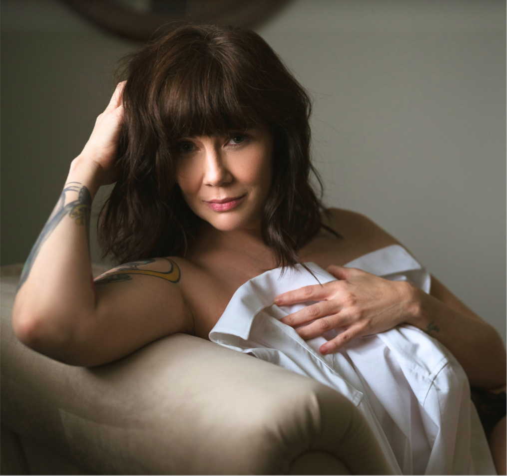 girl smirking on chair boudoir pose