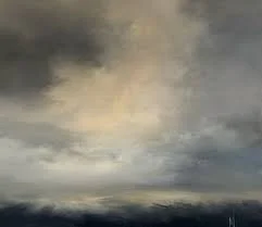 A cloudy sky with dark gray and light beige clouds