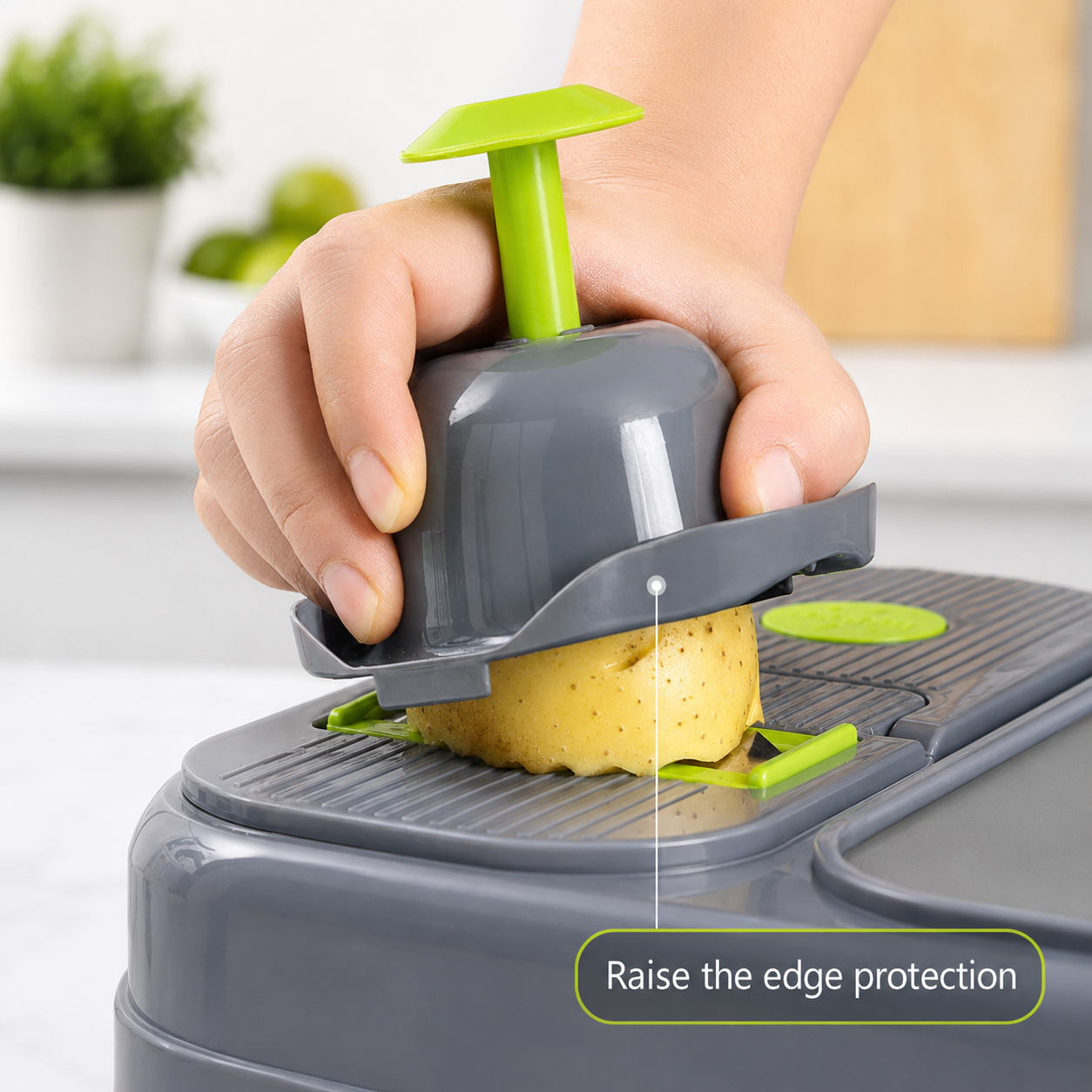 Hand guard being used with mandoline slicer to help protect fingers while slicing a potato