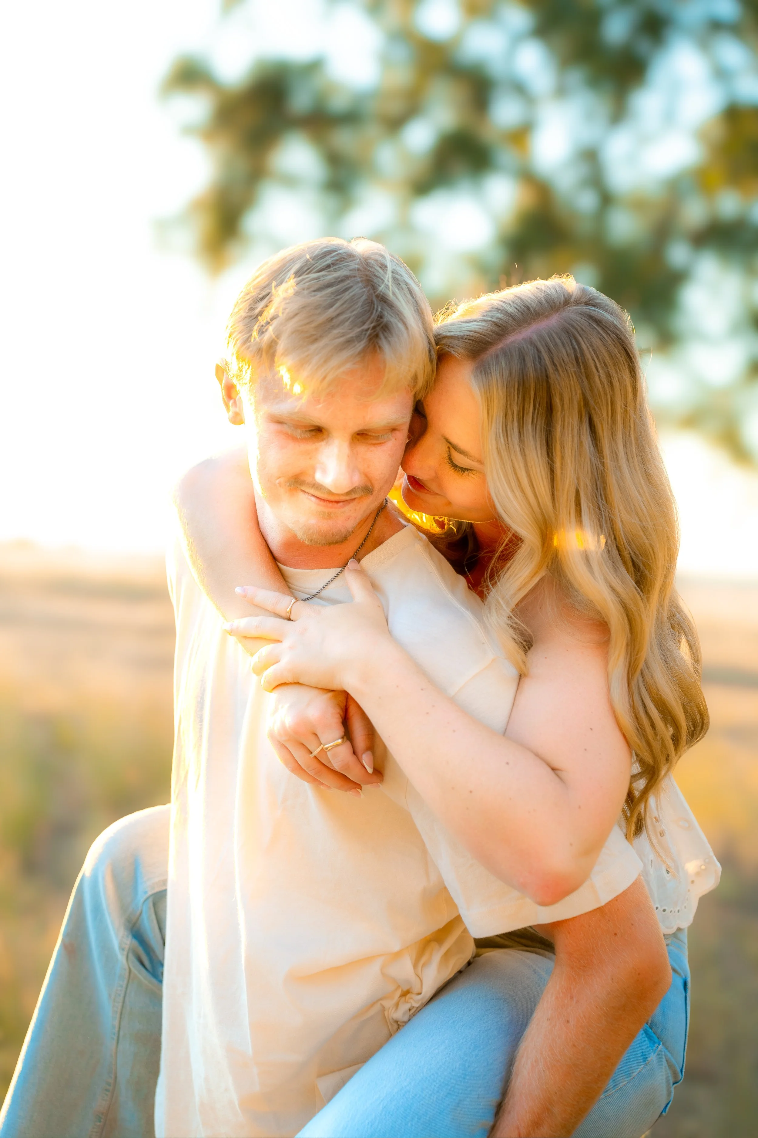 A young couple hugging outdoors during sunset during a couples session in Bidwell Park in Chico, CA.