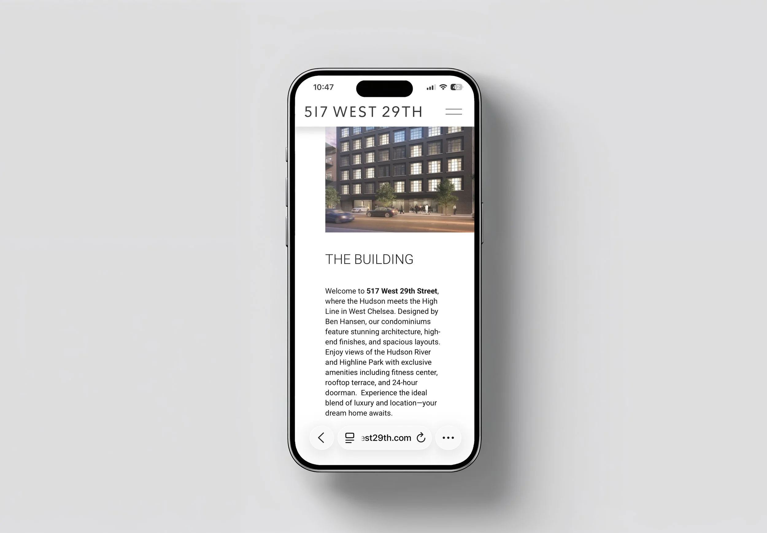 Smartphone displaying a real estate website for 517 West 29th Street featuring a building with multiple lit windows and parked cars on the street.