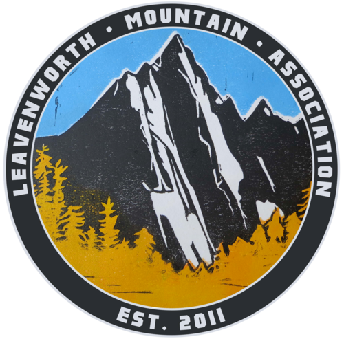A circular logo featuring a mountain with trees at its base and a blue sky background. Text around the circle reads 'Leavenworth Mountain Association' and 'Est. 2011'.