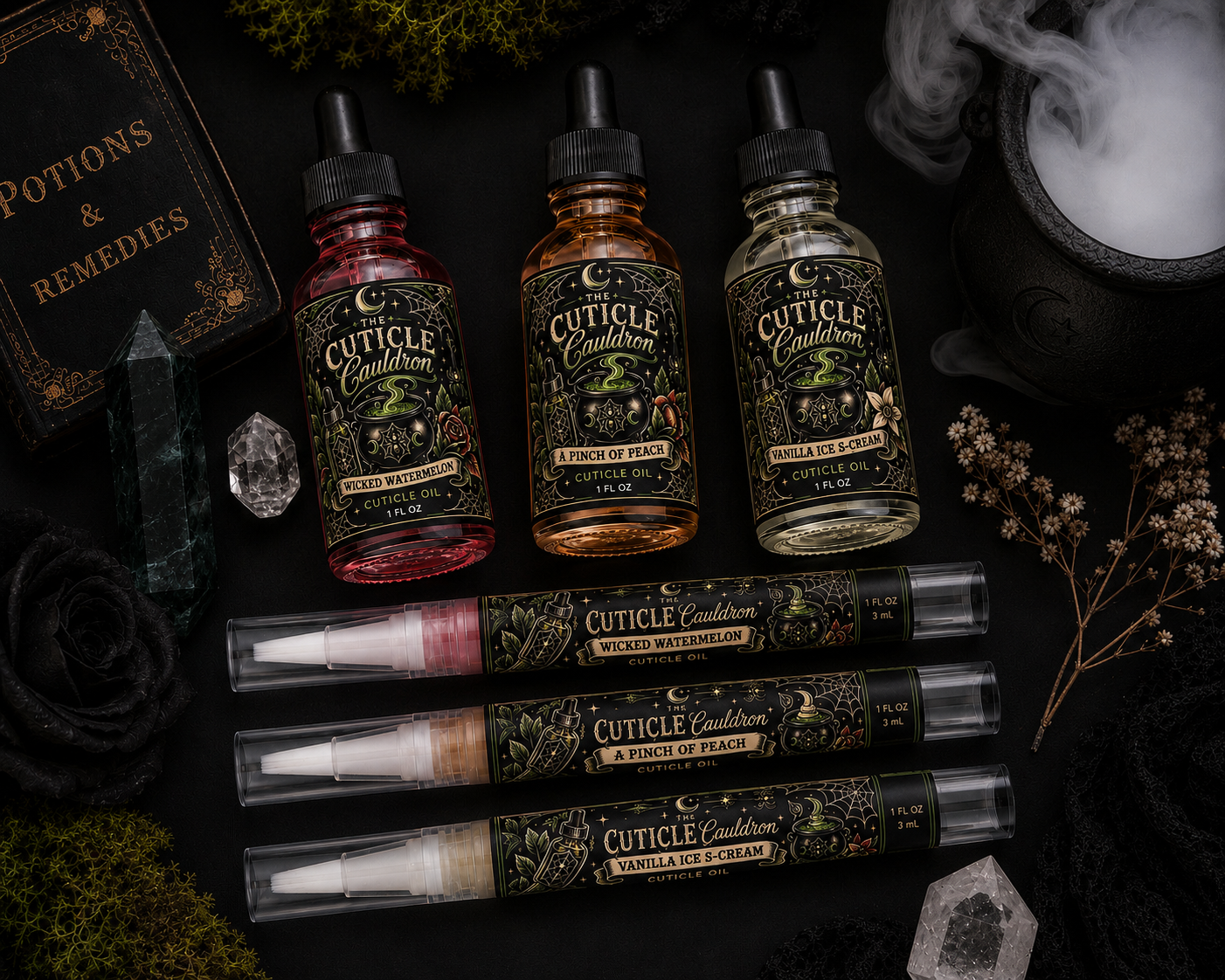 Assorted bottles of cuticle oil labeled Wicked Watermelon, A Pinch of Peach, and Vanilla Ice S-Cream on a dark surface, surrounded by black roses, dried flowers, crystals, and a steaming cauldron, with a potion book nearby.