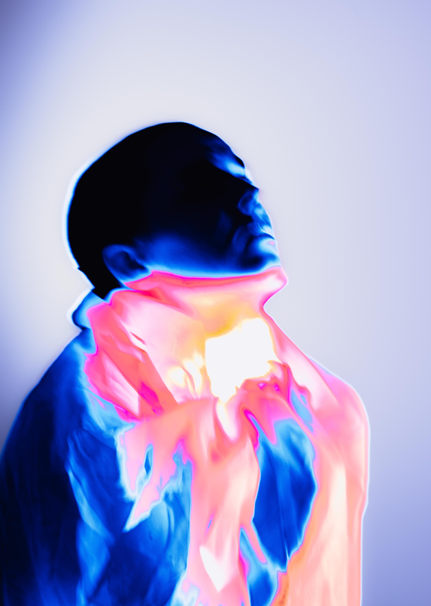Silhouette of a man with glowing effects, emphasizing the profile, with vibrant pink and blue colors, against a light background.