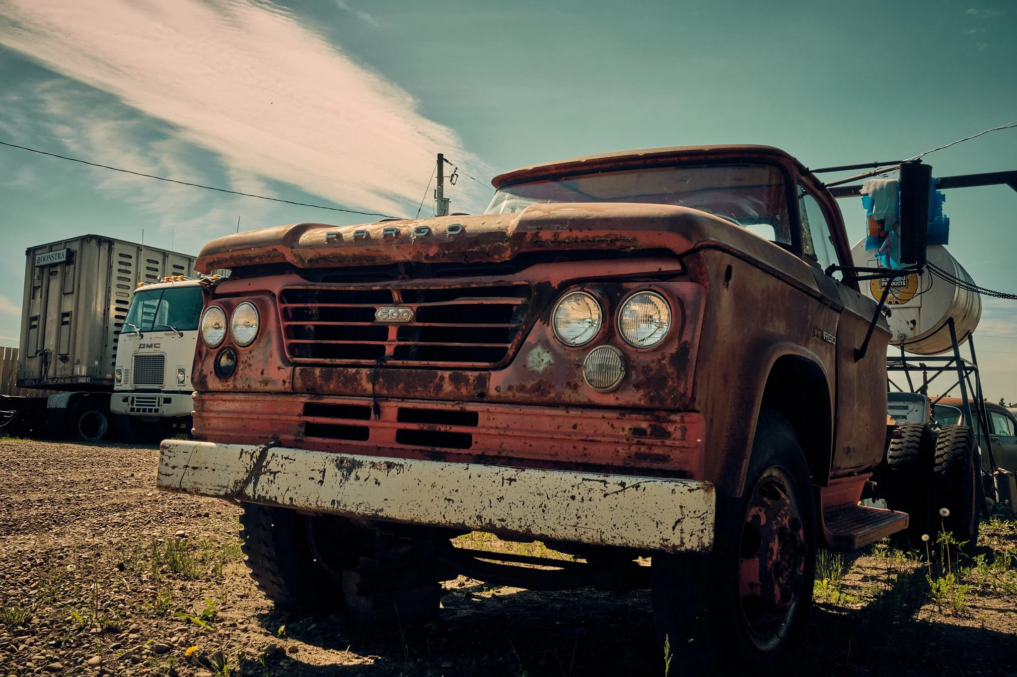 An old, rusted red truck with 