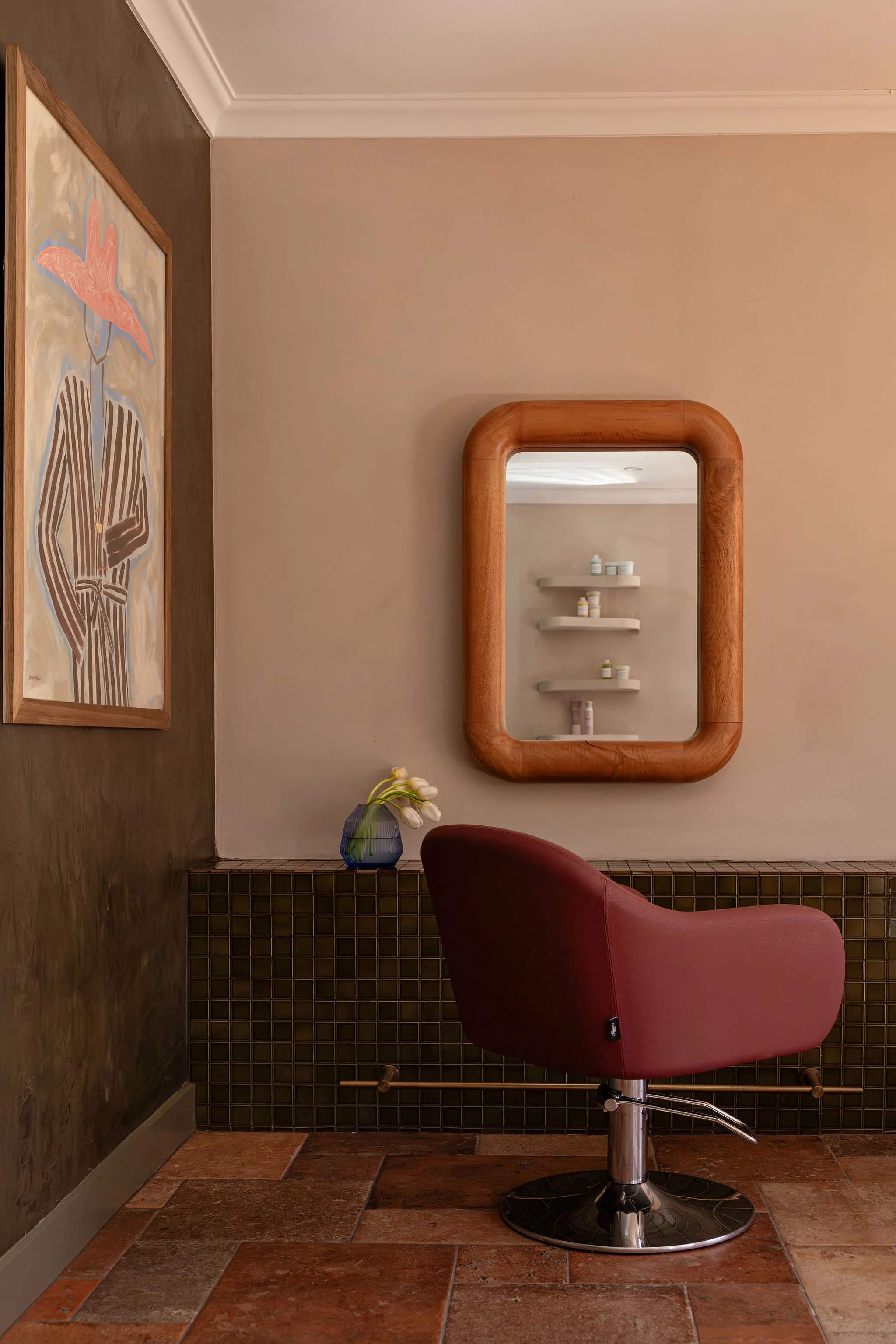Salon Billy styling station with a burgundy salon chair and mirror.