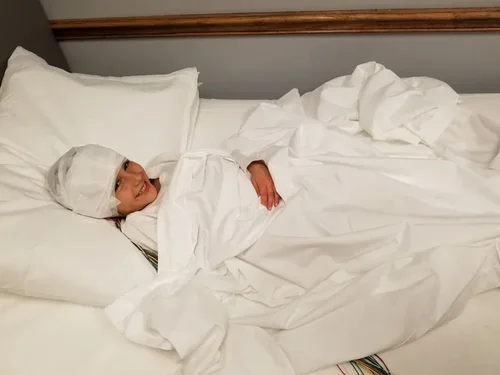 A child resting on a bed during an EEG recording