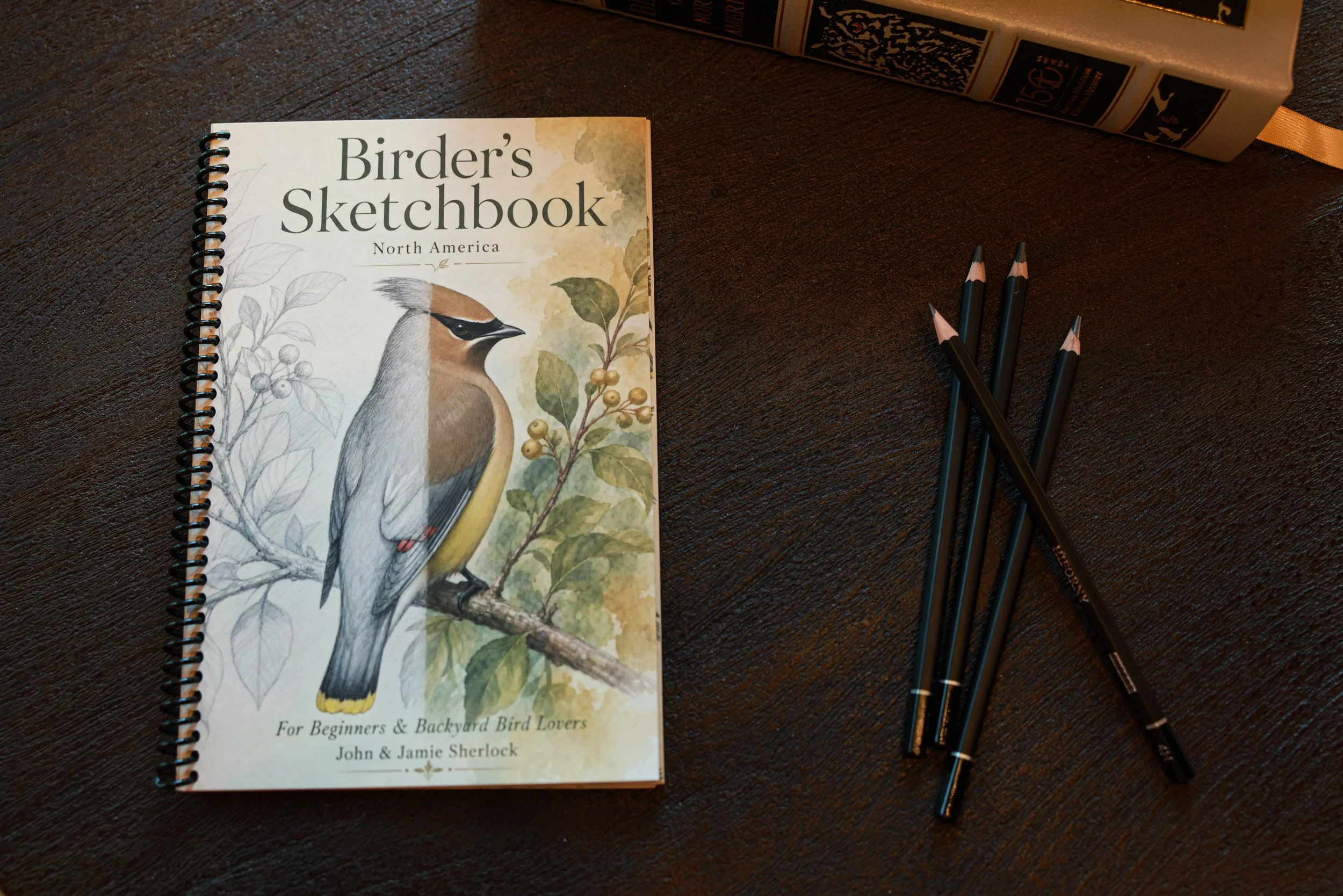 "Birder's Sketchbook North America cover featuring a cedar waxwing illustration by John and Jamie Sherlock"