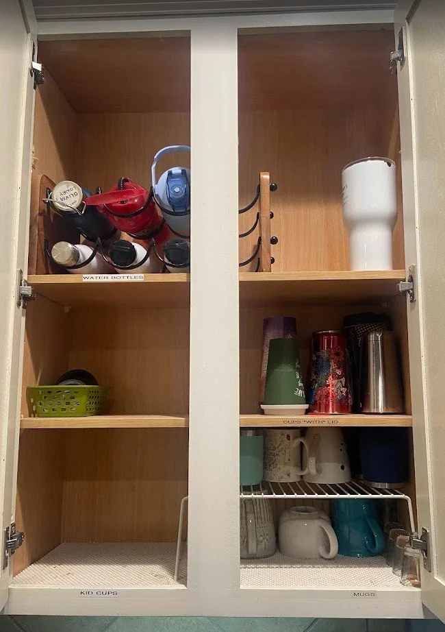 inside a cupboard containing cup and mug storage in Magnolia, TX