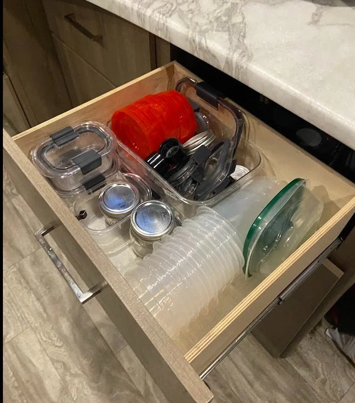 Tupperware storage in a pullout drawer of a kitchen in an RV located in Conroe, TX