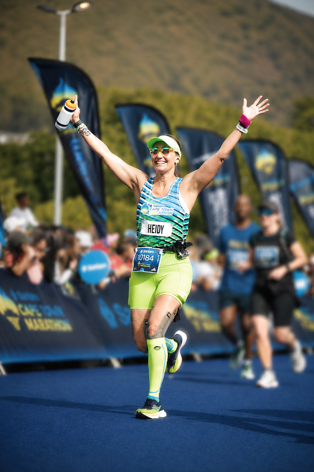 Heidy Arellano crossing the finish line of the Sanlam Cape Town Marathon, the newest Abbott World Marathon Major, celebrating an unforgettable international marathon achievement.