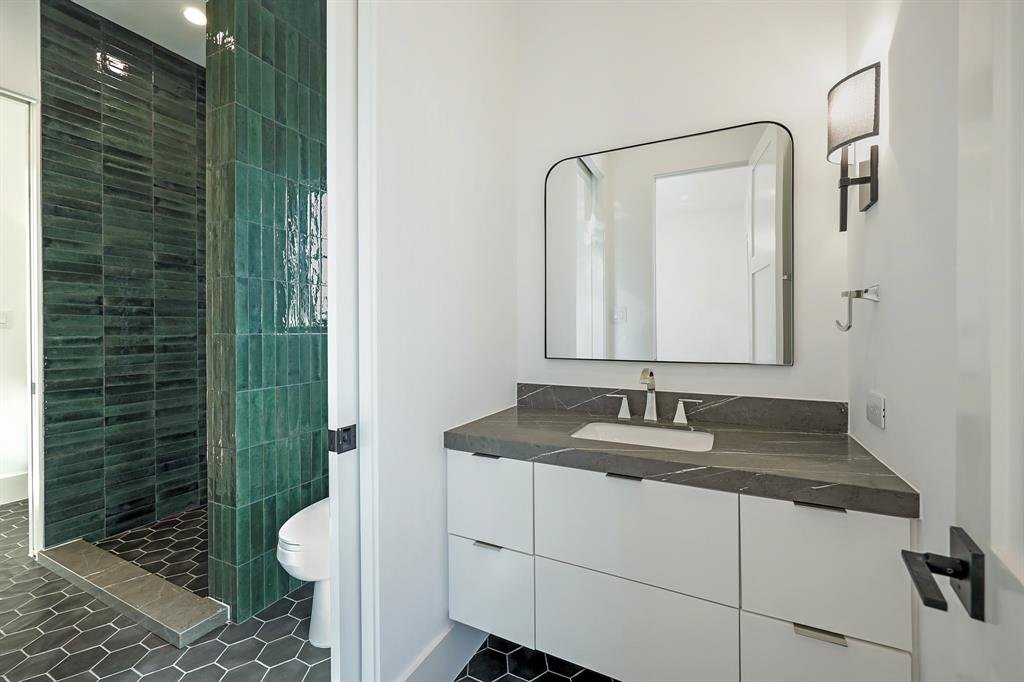 Modern white bathroom vanity with a dark stone countertop and rectangular mirrors. Bathroom Countertops Houston, ‪713-568-5758‬